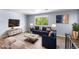 A staged living room with hardwood floors, bright window and stylish furniture at 1155 S Fairplay Cir # D, Aurora, CO 80012