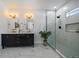 Bright bathroom with black double vanity, mirrors, gold hardware, and modern glass enclosed shower at 3315 N Josephine St, Denver, CO 80205