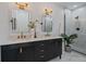 Bathroom featuring double vanity with gold hardware, mirrors and a glass enclosed shower with tiled walls at 3315 N Josephine St, Denver, CO 80205