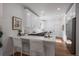 Modern kitchen with white cabinets, quartz countertops, and stainless appliances at 3315 N Josephine St, Denver, CO 80205