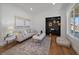 Cozy living room featuring a modern couch, accent rug, and unique storage at 3315 N Josephine St, Denver, CO 80205