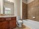Bathroom featuring a vanity with dark wood cabinets and tiled shower and tub at 8983 E Nichols Pl, Centennial, CO 80112