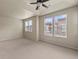 Spacious bedroom with tray ceiling, ceiling fan, and large windows at 8983 E Nichols Pl, Centennial, CO 80112