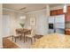 Dining area adjacent to the kitchen featuring a modern chandelier and stainless steel refrigerator at 8983 E Nichols Pl, Centennial, CO 80112