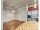 Bright dining area next to the kitchen featuring a modern light fixture and stainless steel refrigerator at 8983 E Nichols Pl, Centennial, CO 80112