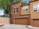 Exterior elevation showcasing brick and siding with attached garage at 8983 E Nichols Pl, Centennial, CO 80112