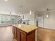 Open-concept kitchen featuring a large island with granite countertop, stainless appliances, and hardwood floors at 8983 E Nichols Pl, Centennial, CO 80112