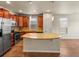 Well-equipped kitchen features stainless appliances, granite countertops, and a center island at 8983 E Nichols Pl, Centennial, CO 80112