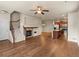 Open-concept floor plan with hardwood floors, fireplace, and modern kitchen with stainless steel appliances at 8983 E Nichols Pl, Centennial, CO 80112
