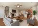 Spacious living room featuring a fireplace, adjacent to the kitchen and dining area at 8983 E Nichols Pl, Centennial, CO 80112