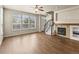 Bright and airy living room with fireplace and staircase featuring hardwood floors and ample natural light at 8983 E Nichols Pl, Centennial, CO 80112