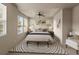 Stylishly furnished main bedroom with tray ceiling, bench, rug, and ample natural light at 8983 E Nichols Pl, Centennial, CO 80112