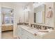 Bathroom featuring double vanity and an adjacent bedroom at 3000 E 112Th Ave # 102, Northglenn, CO 80233