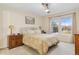 Cozy bedroom featuring two windows and a ceiling fan at 3000 E 112Th Ave # 102, Northglenn, CO 80233