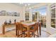 Modern dining room with slate-top wooden table near sliding glass doors and large window at 3000 E 112Th Ave # 102, Northglenn, CO 80233