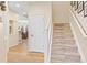 Inviting entryway with wood floors leads to staircase and dining area at 3000 E 112Th Ave # 102, Northglenn, CO 80233