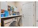 Laundry room features side by side front load washer dryer with folding counter and storage at 3000 E 112Th Ave # 102, Northglenn, CO 80233