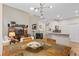 Open concept room with dining table in foreground, kitchen and living room in background at 3000 E 112Th Ave # 102, Northglenn, CO 80233