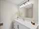 Well-lit bathroom featuring a modern vanity with a large mirror and stylish fixtures at 8387 N Sunburst Trl, Parker, CO 80134