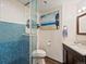 Chic bathroom with modern vanity, glass-enclosed shower, and unique tilework at 8387 N Sunburst Trl, Parker, CO 80134