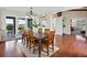 Open dining room with a decorative chandelier, hardwood flooring, and sliding door access to the patio at 8387 N Sunburst Trl, Parker, CO 80134