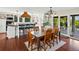 Spacious dining room with hardwood floors next to large kitchen with a breakfast bar at 8387 N Sunburst Trl, Parker, CO 80134