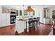 Bright eat-in kitchen featuring a large island, modern appliances, and hardwood flooring at 8387 N Sunburst Trl, Parker, CO 80134