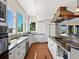 Bright, spacious kitchen with ample natural light, white cabinets, and black countertops at 8387 N Sunburst Trl, Parker, CO 80134