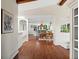 Open-concept space with hardwood floors that connects living room, dining room, and kitchen at 8387 N Sunburst Trl, Parker, CO 80134
