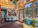 Inviting living room with exposed brick wall, beamed ceiling, and large windows overlooking the backyard at 8387 N Sunburst Trl, Parker, CO 80134