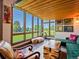 Bright living room with large windows showcasing lush landscaping and comfortable seating at 8387 N Sunburst Trl, Parker, CO 80134