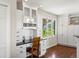 Bright home office with built-in cabinets, desk, and a view of the outdoors at 8387 N Sunburst Trl, Parker, CO 80134