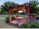 Outdoor seating area under a charming pergola, surrounded by lush landscaping at 8387 N Sunburst Trl, Parker, CO 80134