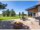 Outdoor patio featuring a fire pit, stone pavers, and expansive backyard at 8387 N Sunburst Trl, Parker, CO 80134