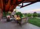 Cozy covered patio with a fire pit and comfortable seating area at 8387 N Sunburst Trl, Parker, CO 80134