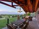 Relaxing outdoor patio with a fireplace, comfortable seating, and scenic views at 8387 N Sunburst Trl, Parker, CO 80134