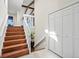 Bright foyer with hardwood stairs and white railing leading to the main living area at 8387 N Sunburst Trl, Parker, CO 80134