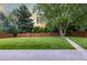 Expansive backyard featuring lush green grass, mature trees, and a wooden fence for added privacy at 2644 S Krameria St, Denver, CO 80222
