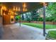 Spacious covered patio with string lights, and a view of the green lawn and trees at 2644 S Krameria St, Denver, CO 80222
