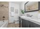 Well-lit bathroom with a large vanity, tiled shower, and modern fixtures at 2644 S Krameria St, Denver, CO 80222
