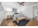 Comfortable bedroom with hardwood floors, a ceiling fan, and an accent bench at 2644 S Krameria St, Denver, CO 80222