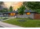 Beautiful home with well-manicured front yard featuring a young tree and lush green grass at 2644 S Krameria St, Denver, CO 80222