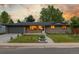 Charming brick home featuring a well-maintained lawn and an attached two-car garage at 2644 S Krameria St, Denver, CO 80222