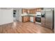 Well-lit kitchen with wood floors, stainless steel appliances, and light wood cabinets at 2644 S Krameria St, Denver, CO 80222