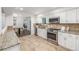Modern kitchen with stainless steel appliances, granite counters, and open layout to the dining area at 2644 S Krameria St, Denver, CO 80222