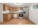 Functional kitchen featuring wooden cabinetry, stainless steel appliances, and a bright window at 2644 S Krameria St, Denver, CO 80222