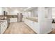 Large kitchen featuring stainless appliances, granite countertops, white cabinets, and tiled floors at 2644 S Krameria St, Denver, CO 80222