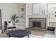 A well-lit living room showcasing a fireplace with mantel and built-in shelves at 2644 S Krameria St, Denver, CO 80222
