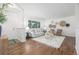 Bright living room with wood floors, neutral furniture, and large windows at 2644 S Krameria St, Denver, CO 80222
