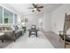 Bright living room featuring a ceiling fan, neutral walls, and a cozy seating area at 2644 S Krameria St, Denver, CO 80222